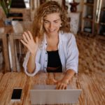 photo of woman saying hi through laptop